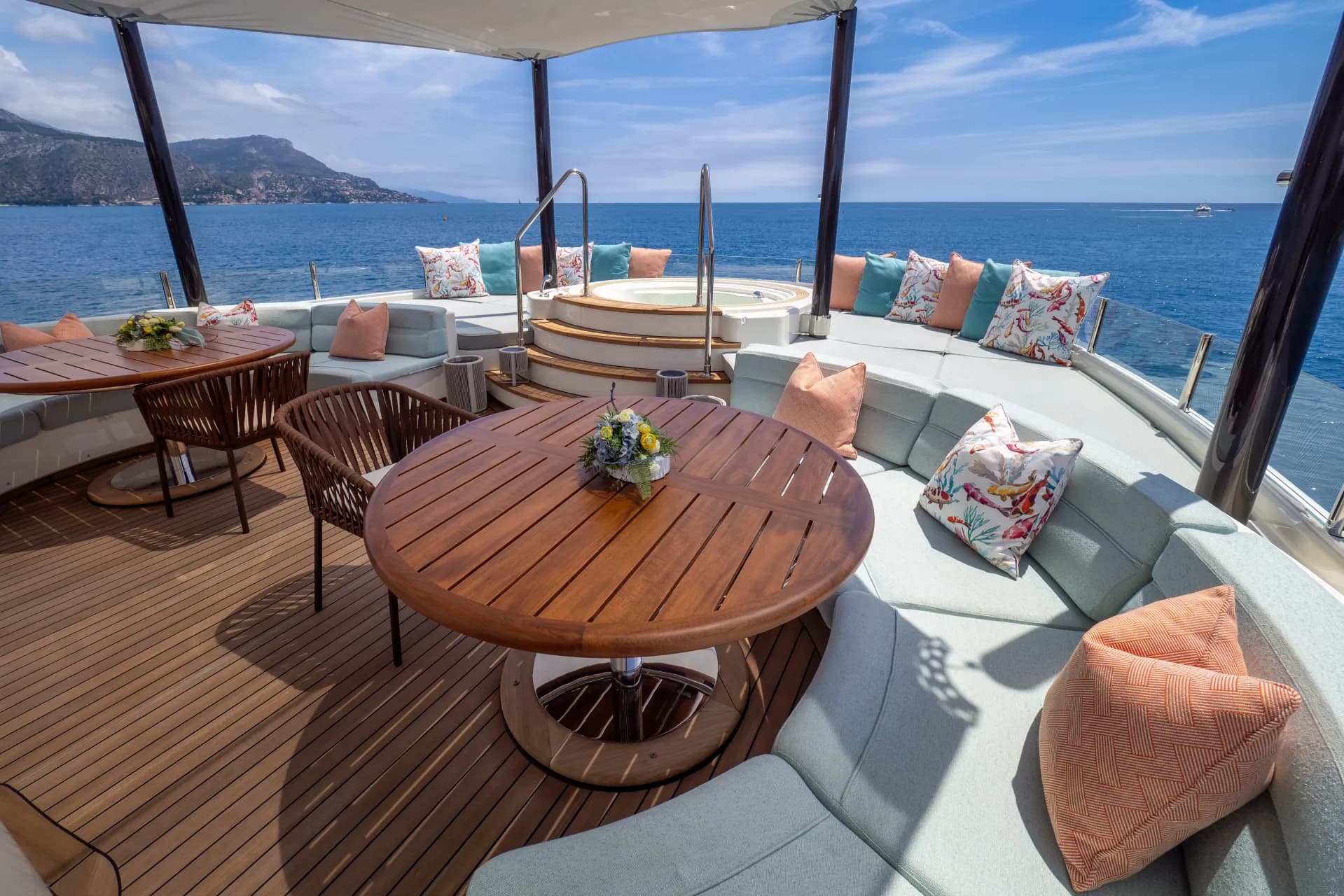 HANA's sundeck — teak loungers, dining and jacuzzi with open sea views